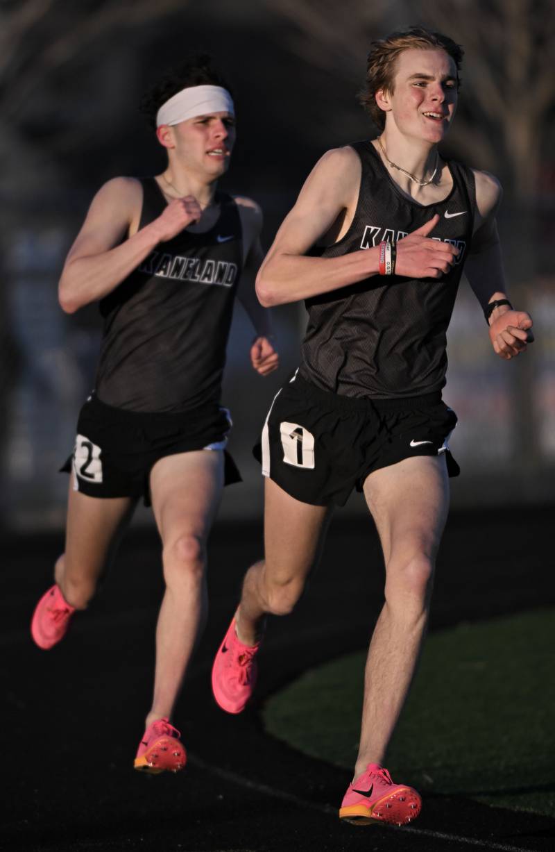 Kaneland's Evan Nosek leads teammate David Valkanov through the last turn of the 1,600-meter run at the Les Hodge Boys Track and Field Invitational at Batavia High School on Friday, April 5, 2024.