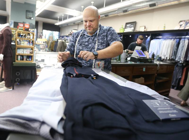 Jermey Reed owner of That Guys Secret, hems a pair of pants in his store on Monday, Nov. 6, 2023. Fourth-quarter sales at local small businesses are on the rise throughout the Illinois Valley.