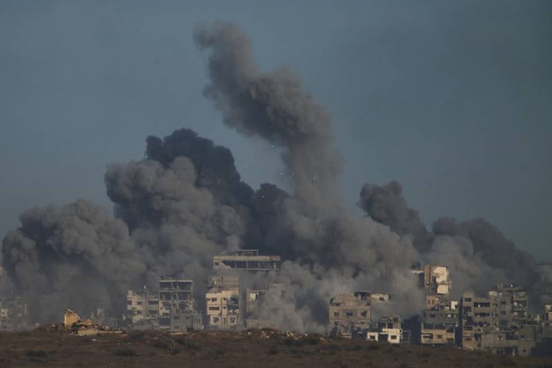 Smoke billows over Gaza Strip following an Israeli bombardment, as seen from southern Israel, Sunday, Oct. 5, 2025. (AP Photo/Ariel Schalit)