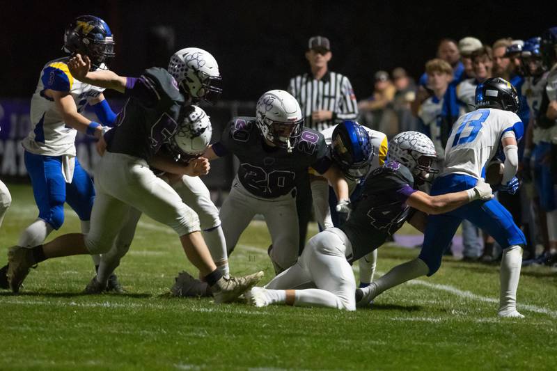 Wilmington players go for a tackle during the Wildcats' 49-7 victory over Tri-Valley in the quarterfinal game on Saturday, Nov. 15, 2025.