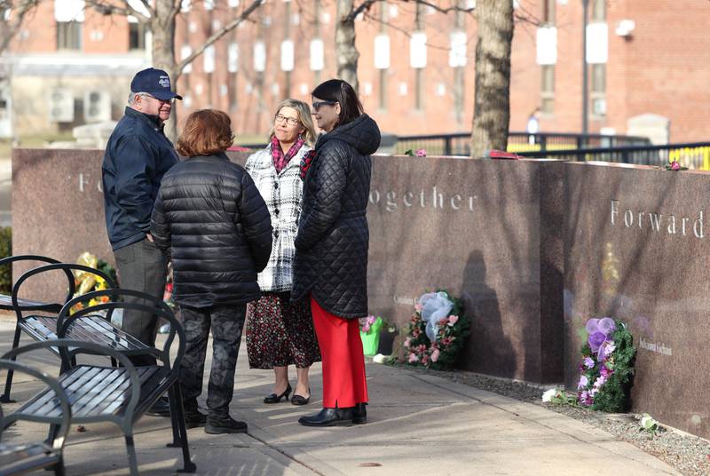 Larry Gehant and Charlotte Schiller, (left) aunt and uncle of shooting victim Julianna Gehant, talk to representatives from Northern Illinois University Wednesday, Feb. 14, 2024, during a ceremony in the Peaceful Reflection Garden near Cole Hall honoring the victims of the 2008 shooting at NIU in DeKalb. Wednesday marked 16 years since the deadly shooting took place on campus which took the lives of five people.