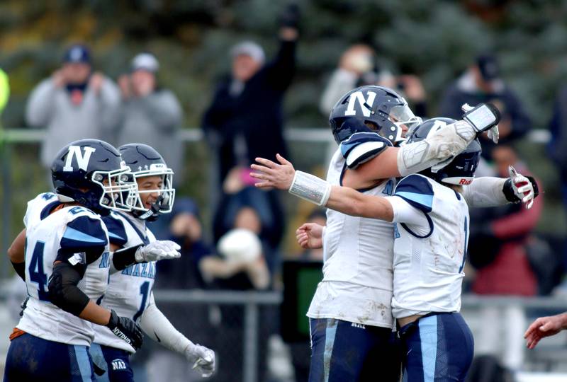 Nazareth’s Roadrunners celebrate a win over Prairie Ridge in first-round Class 5A playoff football action at Crystal Lake Saturday.