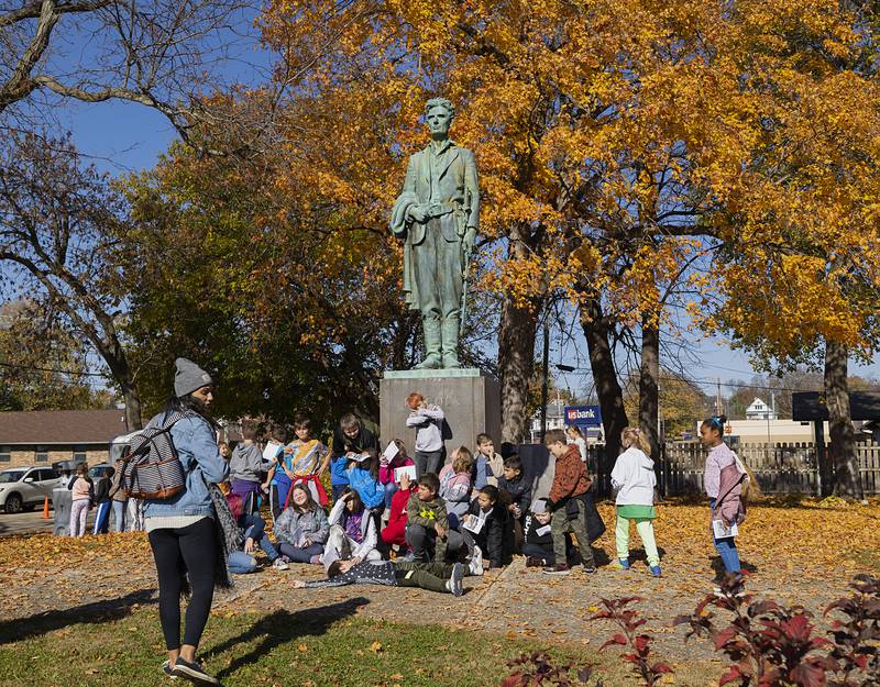 Reagan Middle School fourth grade teacher Alicia McPhillips rounds up her class to snap a photo in front of the Lincoln statue at Presidents Park in Dixon. The annual tour is helped out by many volunteers to teach the students about the history of Dixon.