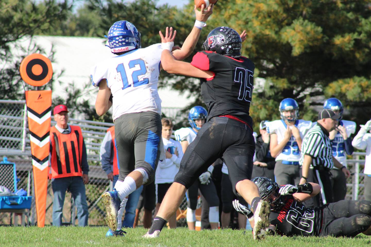 Erie-Prophetstown lineman Nick Ballard (75) pressures Clifton Central quarterback Luke Shoven (12) on Saturday, Oct. 30, 2021, in a Class 2A playoff game at Erie High School.  Shoven through three interceptions and was sacked once by Ballard.