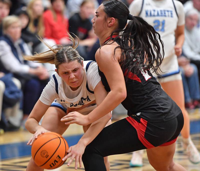 Nazareth’s Stella Sakalas drives into Benet’s Emma Briggs during a game on December 13, 2025 at Nazareth Academy in LaGrange Park.