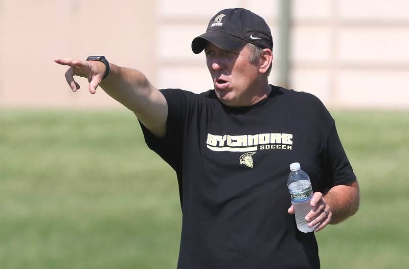 New Sycamore boys varsity soccer coach Kevin Bickley talks to his team Wednesday, June 29, 2022, during summer boys soccer practice at the school.