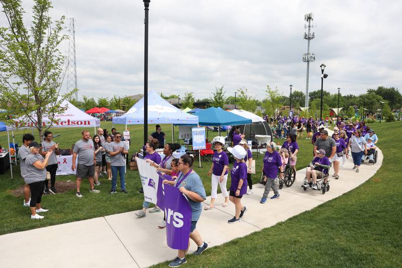 Cancer survivors area applauded as they walk the first lap during the Relay for Life of Kankakee County on June 14, 2025, at The Grove in Bourbonnais.