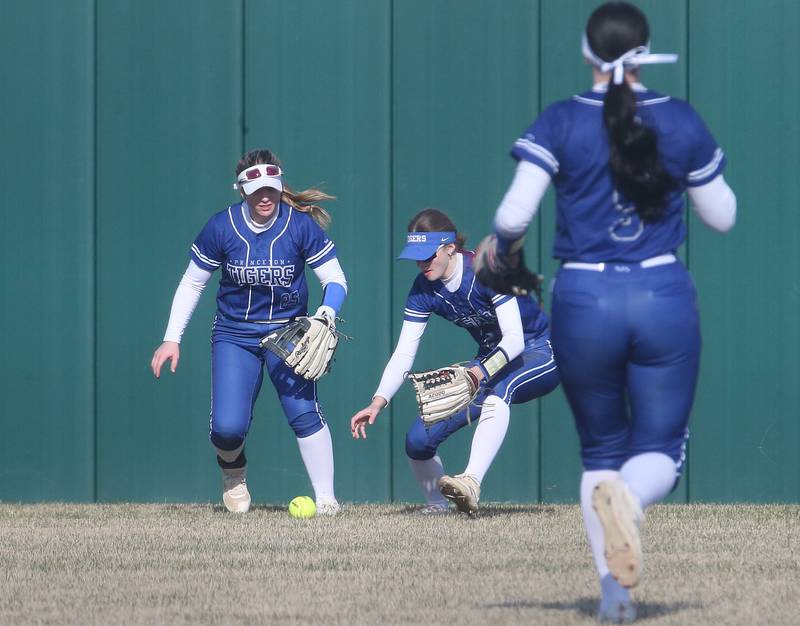 Princeton outfielders Kelsea Klingenberg and Caroline Keutzer scramble to field a ground ball to throw to the cutoff teammate Keely Lawson while playing L-P on Tuesday, March 25, 2025 at the L-P Athletic Complex in La Salle.