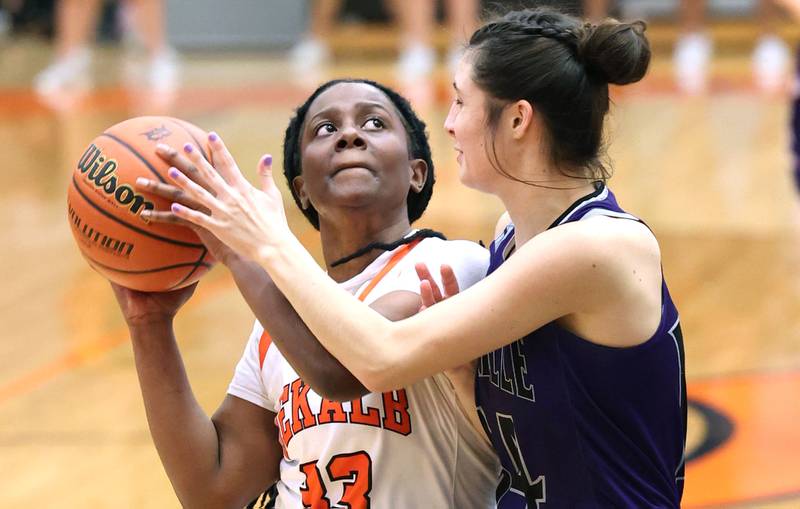 DeKalb's Cayla Evans is fouled on a drive to the basket by Rochelle's Megan Seebach during their game Monday, Nov. 28, 2022, at DeKalb High School.