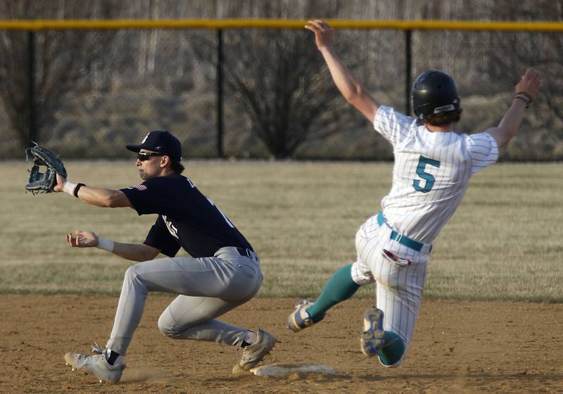 Cary-Grove's Francis Panko catches the ball as Woodstock North's Tristan Schaffter slides into second base during a double play attempt during a nonconference baseball game on Monday, March 30, 2026, at Woodstock North High School.