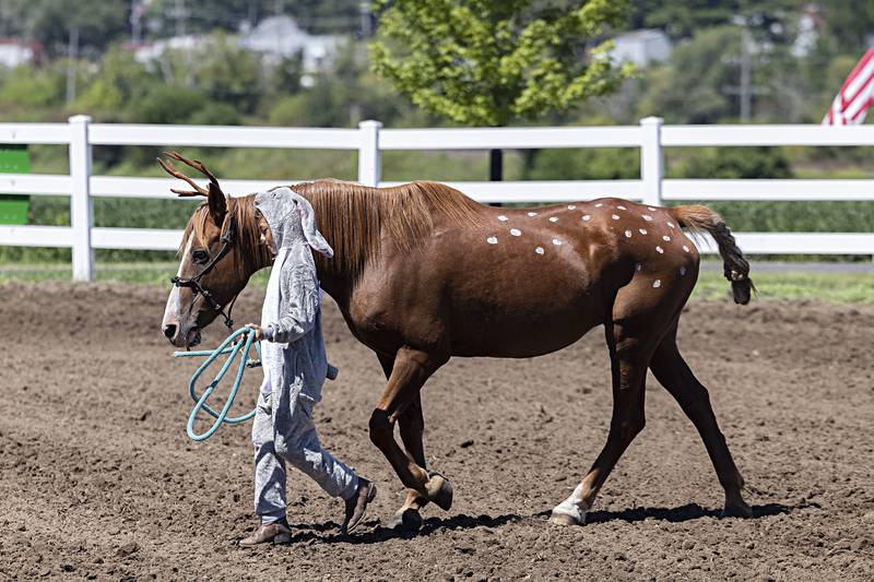 Easrtyn Zumdahl, 10, of Baileyville walks with her horse Tia as Bambi and Thumper in the open costume contest Saturday, August 12, 2023 at the Carroll County Fair.