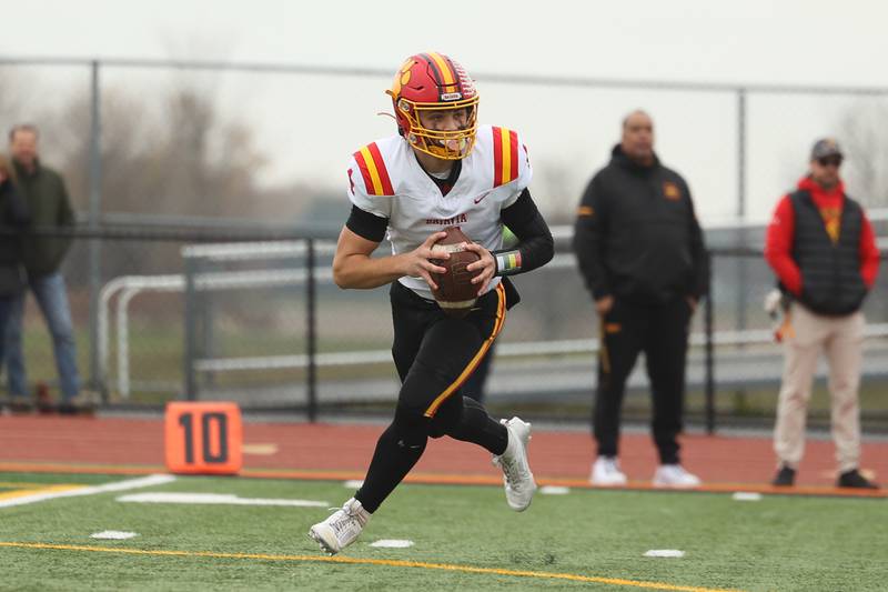 Batavia’s Bodi Anderson rolls out to pass against Lincoln-Way West on Saturday, Nov. 9, 2024 in New Lenox.