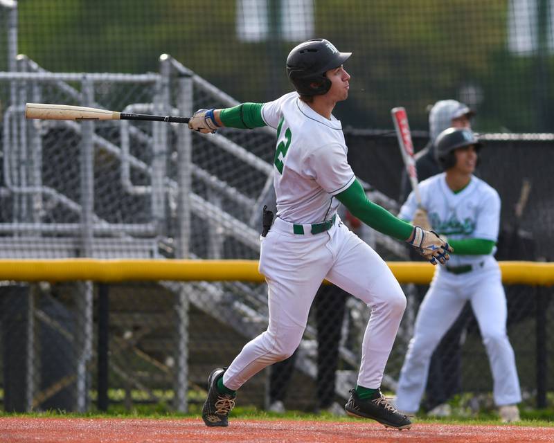 York's Josh Fleming (12) watches the ball after making contact and getting a two-run homer during the game on Monday May 19, 2025, while taking on Downers Grove North held at York High School in Elmhurst.