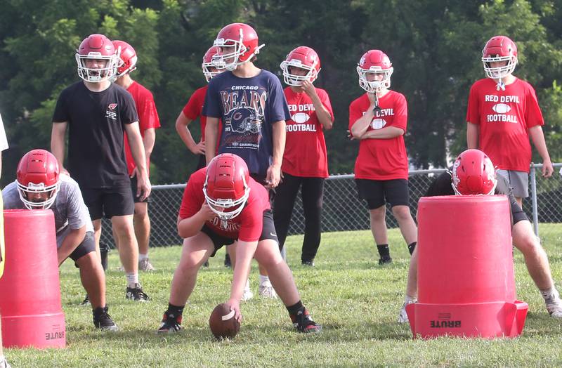 Members of the Hall high School football team run drills during camp on Thursday, July 24, 2025 at Hall High School.