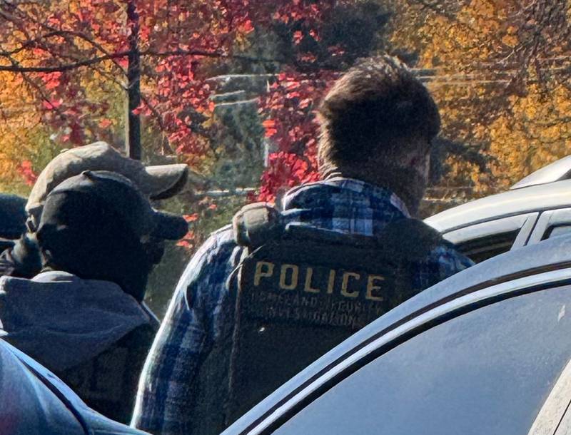 Agents wearing masks and vests that say Homeland Security take a man into custody outside the McHenry County courthouse in Woodstock on Wednesday, Nov. 5, 2025. Eye witnesses said the officers smashed the driver's side window of a car to detain the man.
