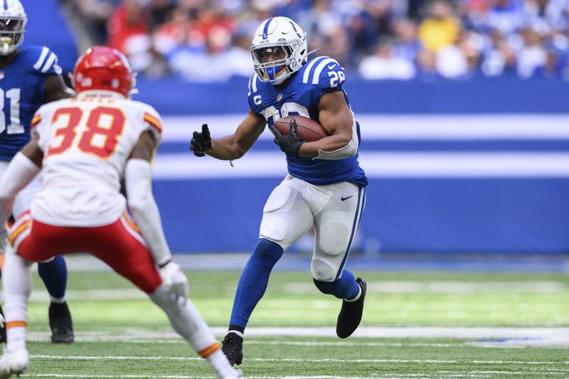 Indianapolis Colts running back Jonathan Taylor (28) runs up the middle during an NFL football game against the Kansas City Chiefs, Sunday, Sept. 25, 2022, in Indianapolis. (AP Photo/Zach Bolinger)