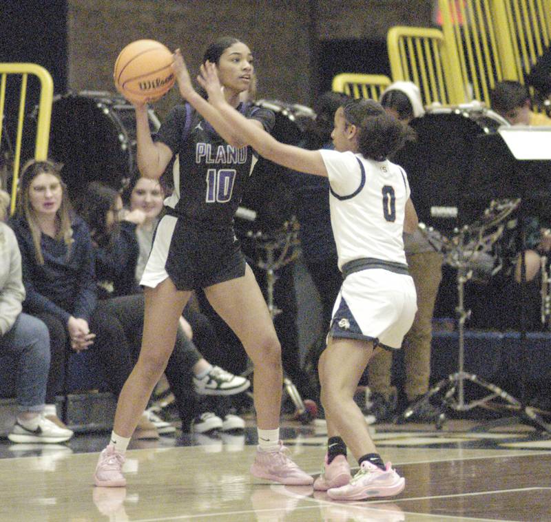 Plano's Jailyn Brown looks to pass over Sterling's Alivia Gibson. Sterling Golden Warriors faced off against Plano Lady Reapers in an IHSA 3A Regional girls final at Musgrove Fieldhouse in Sterling on February 20, 2025.