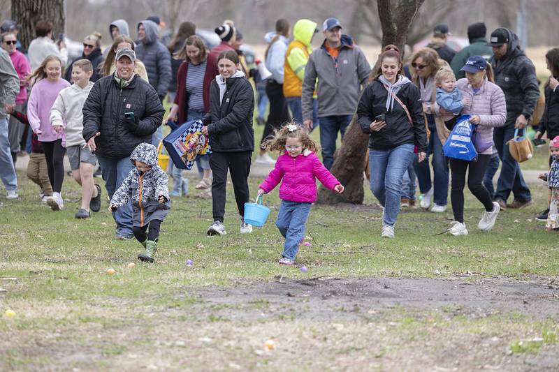 Kids with parents in tow sprint out to gather up eggs Saturday, April 4, 2026, in Amboy.