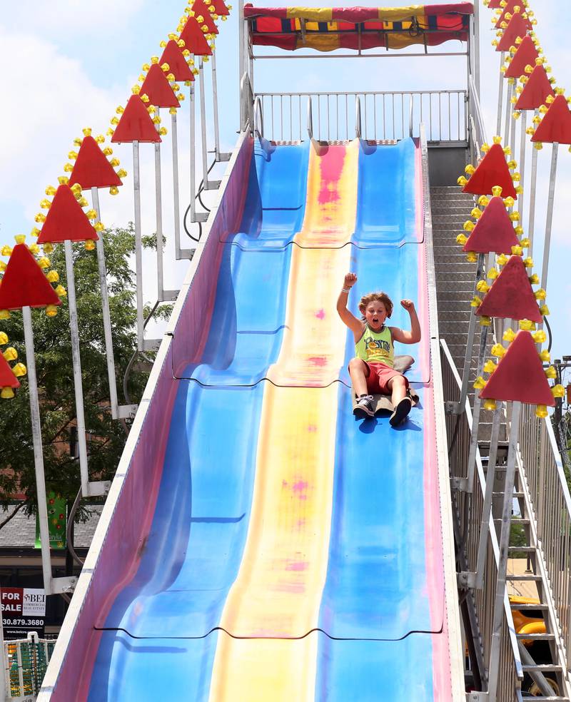 Levi Scigouski, 8, of Batavia rides down the Fun Slide at the Windmill City Festival in Batavia on Saturday, July 13, 2024 in Batavia.