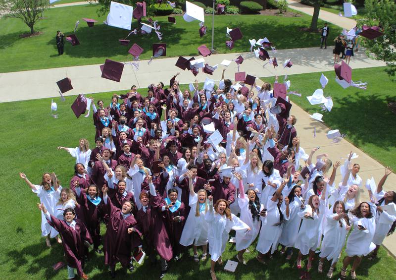 Montini Catholic High School students toss their caps at the graduation ceremony on Sunday, May 22 in Lombard.