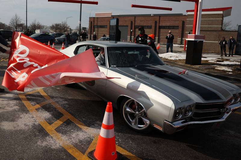 Michael Portillo (driving) and Portillo’s contest winner Frank Ramsey, of Romeoville, “cut” the ceremonial ribbon for the open of the new Joliet Portillo’s location on North Larkin. Tuesday, Feb. 1, 2022 in Joliet.