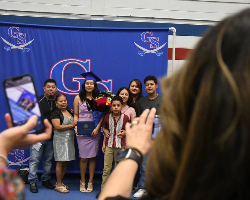 Arleth Caderon poses for a photo with her family after graduating from Glenbard South High School on Thursday May 23, 2024, held at Glenbard South High School.