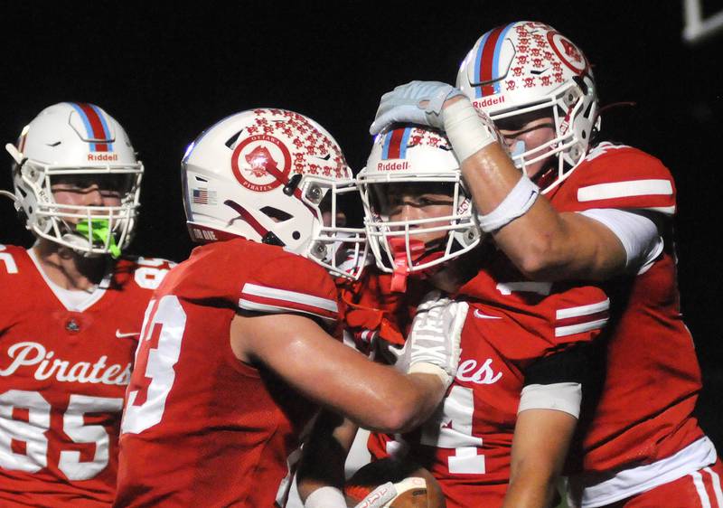 Ottawa's Archer Cechowiz (14) celebrates his touchdown with teammates Dane Carretto (85), Ethan Poutre (13) and Owen Sanders in their homecoming game against Sycamore on Friday, Sept. 26, 2025 at King Field.