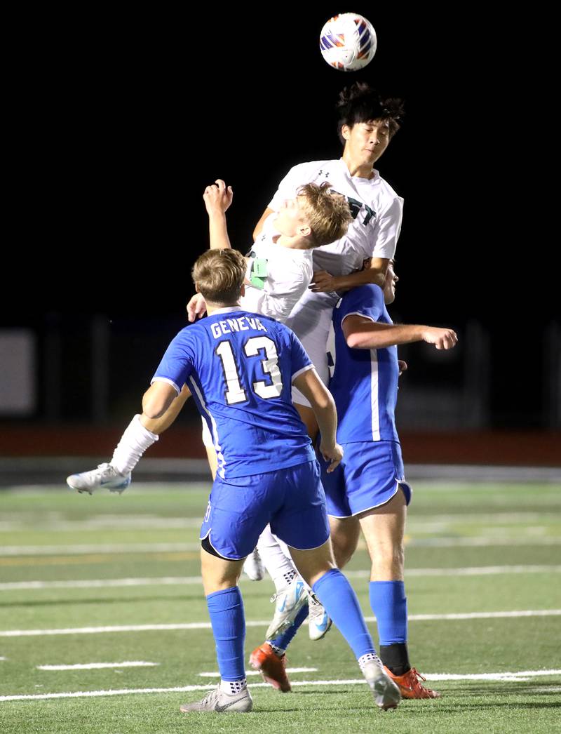 Glenbard West’s Aidan Adachi (top) headst the ball during the Class 3A St. Charles North Sectional semifinal against Geneva on Tuesday, Oct. 29, 2024 in St. Charles.
