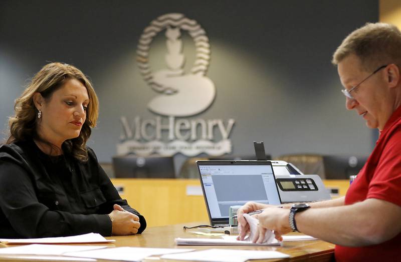 McHenry City Clerk Trisha Ramel files her paperwork Tuesday, Nov. 12, 2024, to run for another term as the city clerk of McHenry with McHenry Deputy Clerk Monte Johnson during first day of filing for the consolidated election on April 1, 2025.