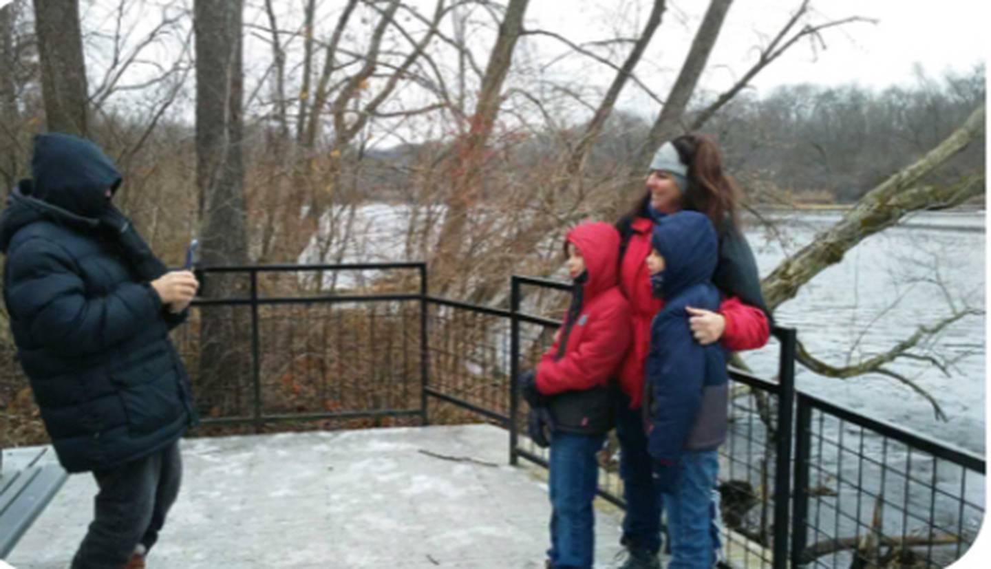 Rebecca Krause of Yorkville has her picture taken before the Fox River with nine-year-old sons Jack, in red, and Drew, in blue, during the annual Kendall County New Year's Hike in Hoover Forest Preserve. (Mark Foster - mfoster@shawmedia.com)