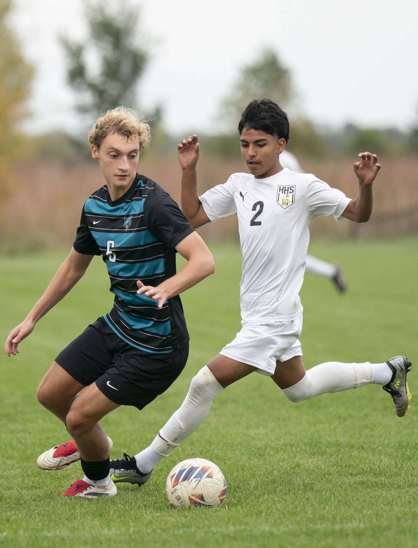 Woodstock North's Barek Blue, left, battles for the ball with Harvard's Eddie Fuentes during the Kishwaukee River Conference Tournament Championship game on Monday, October 6, 2025 at Woodstock North High School. Ryan Rayburn for Shaw Local