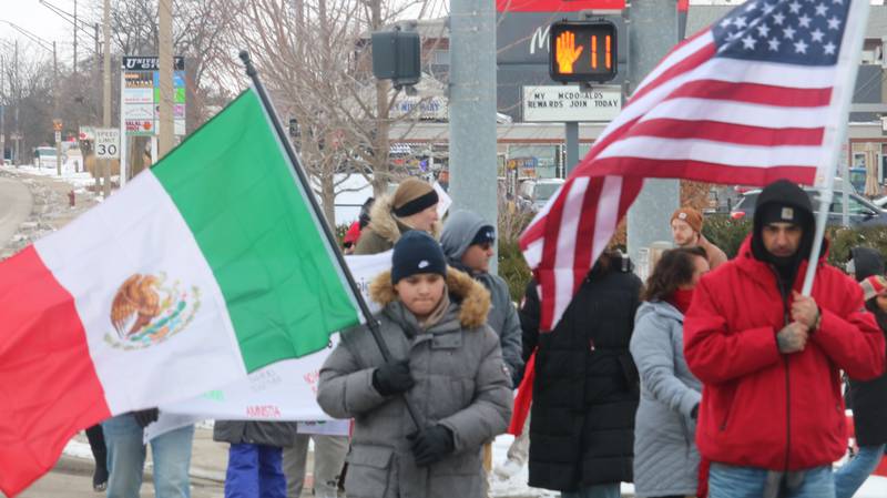 Demonstrators take to the streets of DeKalb Sunday, Feb. 16, 2025, in protest of the federal administration immigration policies.