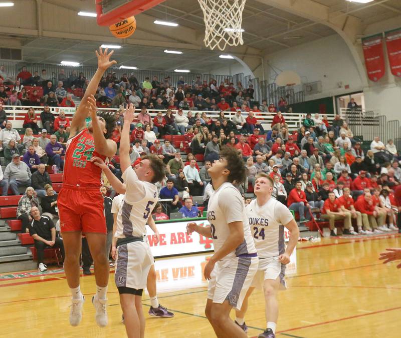 L-P's Marion Persich lets go of a shot in the lane over Dixon's Cullen Shaner during the Class 3A Regional semifinal game on Wednesday, Feb. 26, 2025 in Sellett Gymnasium at L-P High School.