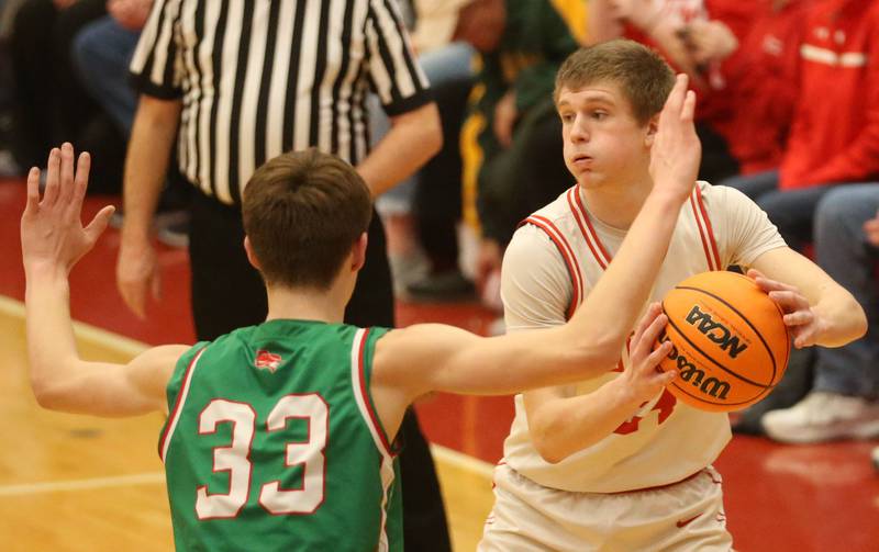 Ottawa's George Shumway looks to pass the ball around L-P's Gavin Stokes on Friday, Feb. 6, 2026 in Kingman Gymnasium at Ottawa High School.