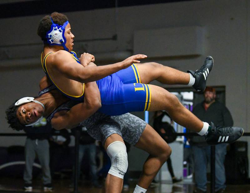 Richie Amakiri of Plano takes down a De LaSalle wrestler in the 195 weight class during the 3rd place matchup Saturday Dec. 10th where he took 4th place at the Plano Reaper wrestling classic held at Plano High School.