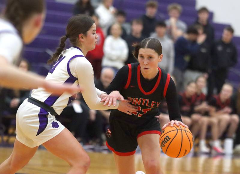 Huntley’s Evie Freundt, right, works past Hampshire’s Veronica Dumoulin in varsity girls basketball on Wednesday, Feb. 11, 2026, at Hampshire High School in Hampshire.