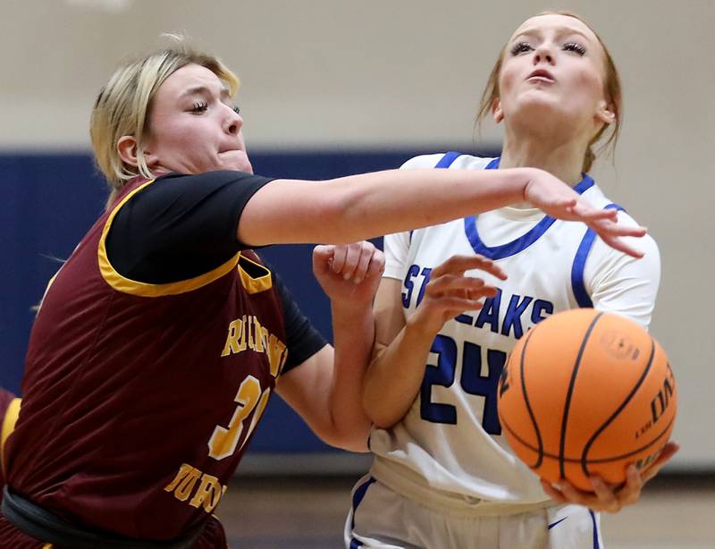 Woodstock's Aiyana Fourdyce (right) dries to the basket against Richmond-Burton's Chase Cooper during a Kishwaukee River Conference girls basketball game on Wednesday, Jan. 28, 2026, at Woodstock High School.