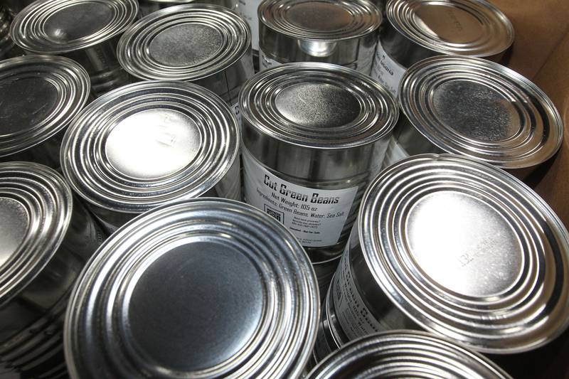 Large cans of cut green beans sit in a box for distribution to neighbors in need at the Northern Illinois Food Bank on August 19th in Lake Forest. The North Suburban Center recently celebrated it’s one-year anniversary at this location.  
Photo by Candace H. Johnson for Shaw Local News Network