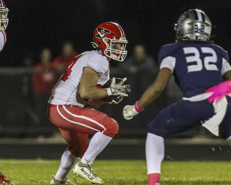 Yorkville's Gavin Geegan (34) is met in the backfield by Oswego East's Jeremy Rivers (32) during football game between Yorkville at Oswego East Friday, Oct 10, 2025 in Oswego.