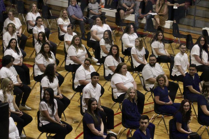 Students in the division of health professions wait for their name to be called at the pinning ceremony on Friday at Sauk Valley Community College.