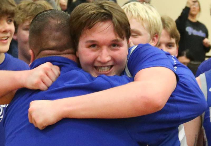 Princeton's Wyatt Koning hugs head coach Jason Smith after defeating Morrison during the Class 2A Regional final game on Friday, Feb. 23, 2024 at Erie-Prophetstown High School.