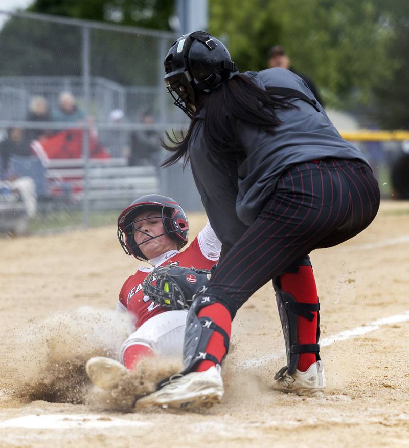 Fulton’s Resse Germann is tagged out at home by Amboy’s Tyrah Vaessen Wednesday, May 21, 2025, during a Regional semifinal softball game.
