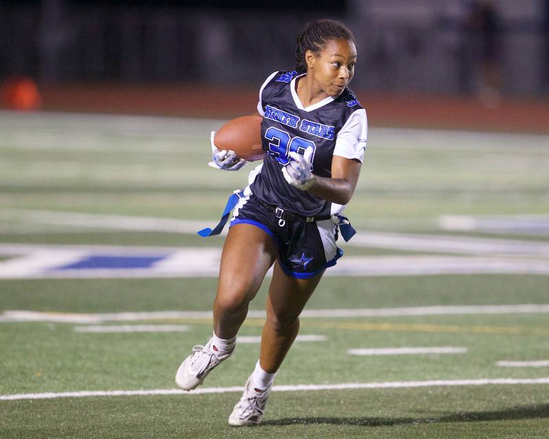 St. Charles North's Jaelynn Hawkins runs the ball for a gain against St. Charles East on Monday, September 29, 2025 in St. Charles.