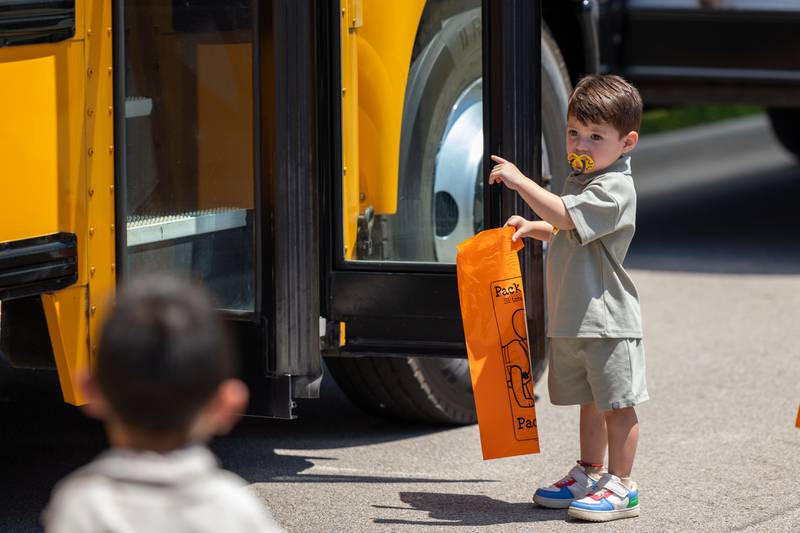 Axel Solis-Sanchez points at school bus at the Touch a Truck event on Saturday, June 28, 2025 at Centennial Park in Peru.