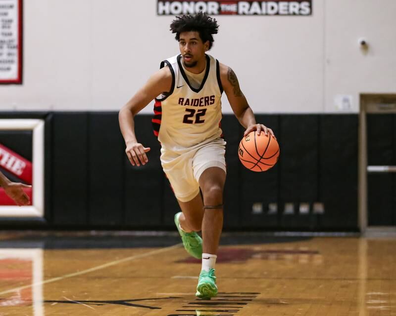 Bolingbrook's Joshua Pettigrew (22) dribbles the ball past half court during their basketball game between Plainfield North at Bolingbrook, Friday Dec 13, 2024 in Bolingbrook.