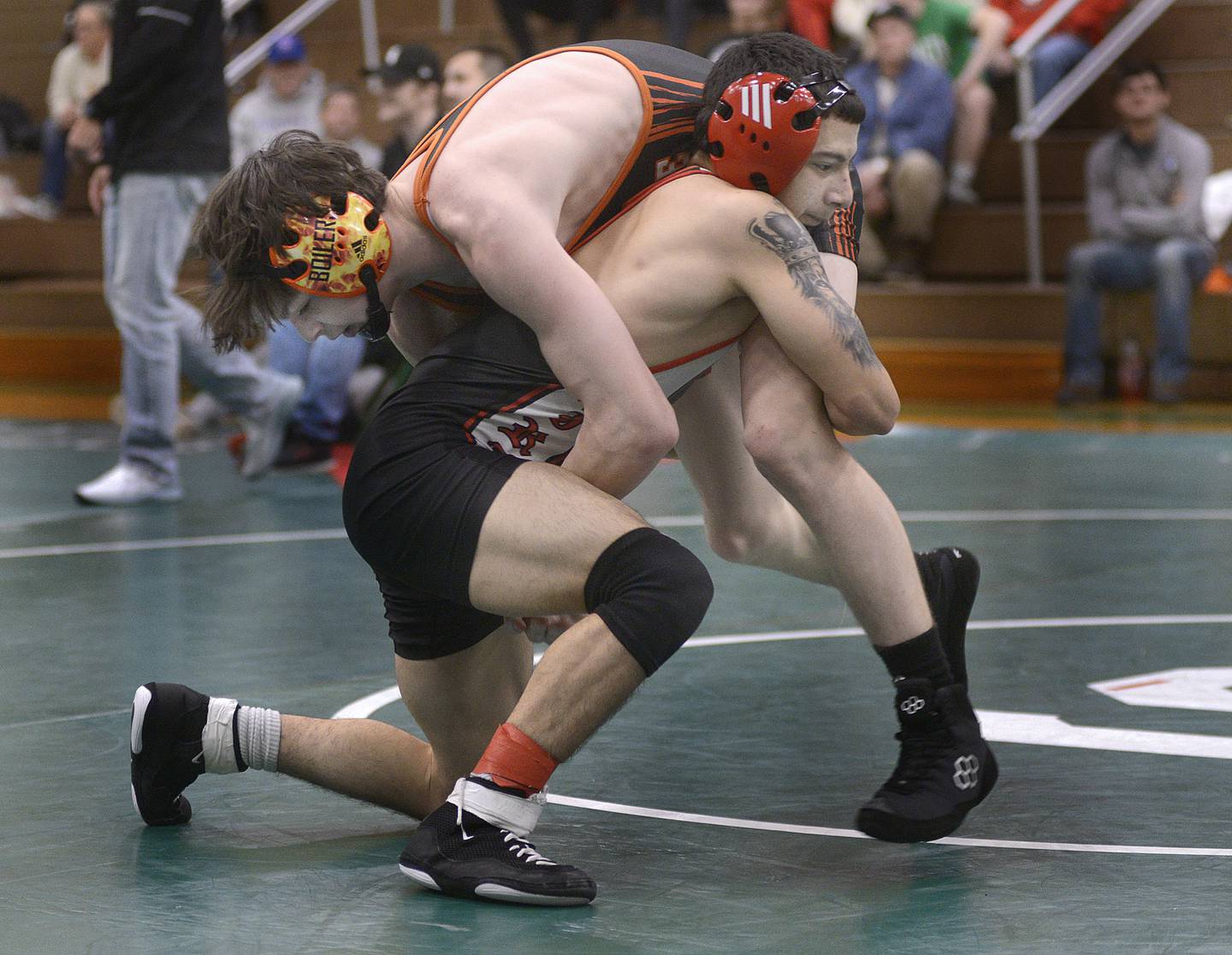 Ottawa senior Ivan Munoz works to bring down Kewanee sophomore Kingston Peterson in the 113-pound championship match of the Seneca Fighting Irish Wrestling Invitational on Saturday at Seneca