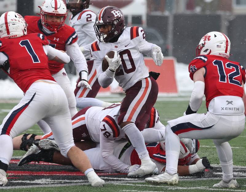 Brother Rice's Jaylin Green runs by St. Rita's Kyle Keyser Wednesday, Dec. 3, 2025, during their IHSA Class 7A state chamionship game in Huskie Stadium at Northern Illinois University in DeKalb.