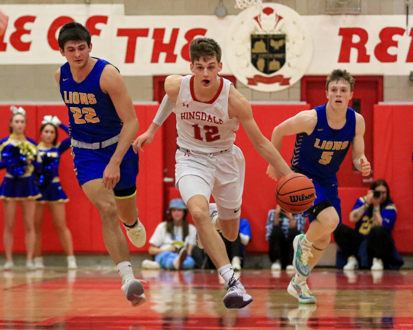 Hinsdale Central's Ben Oosterbaan (12) races down the court during varsity basketball game between Lyons at Hinsdale Central.  Jan 20, 2023.