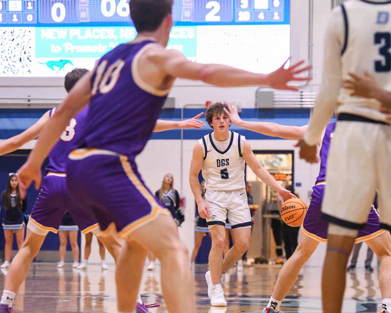Downers Grove South's Wyatt Wawro (5) looks for an open teammate while taking on crosstown rival Downers Grove North on Saturday Dec. 21, 2024, held at Downers Grove South High School.