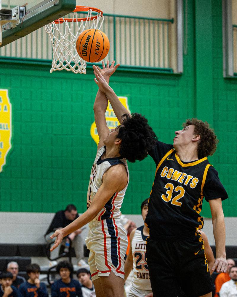 Diego Perez (4) of DePue lays ball up whilst Vinny Bollino (32) of Reed-Custer attempts to block shot during game in the Shipyard Showdown on Tuesday, December 23, 2025 at Seneca High School in Seneca.